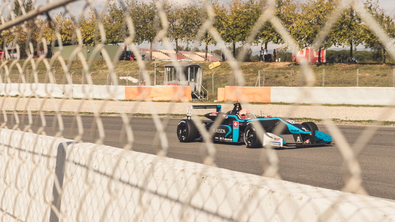 driver, black, transportation, sunlight, sports car, vehicle, track, motor racing track, fence, 2K, race car, airplane, day, formula one, f1, blue, mode of transportation