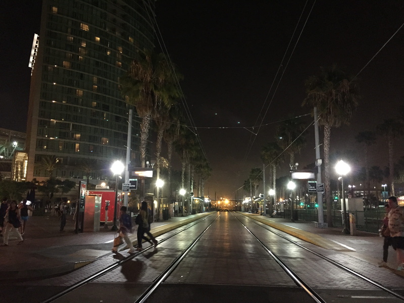 train, outdoors, city life, 99 fifth ave, building, train tracks, walking, city street, downtown, street light, street, city, building exterior, rail transportation