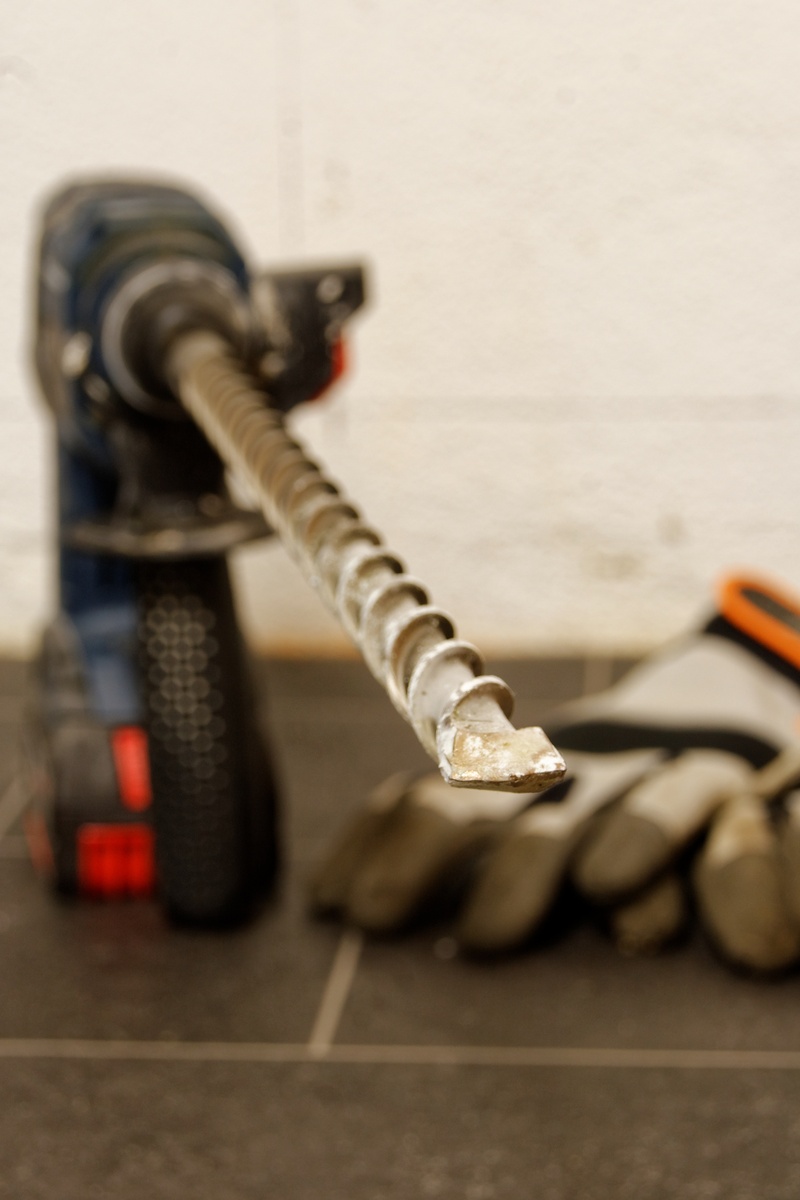 selective focus, gloves, breakthrough, close-up, breakthrough drill bits, communication, cordless, 2K, network connection plug, flooring, protection, indoors