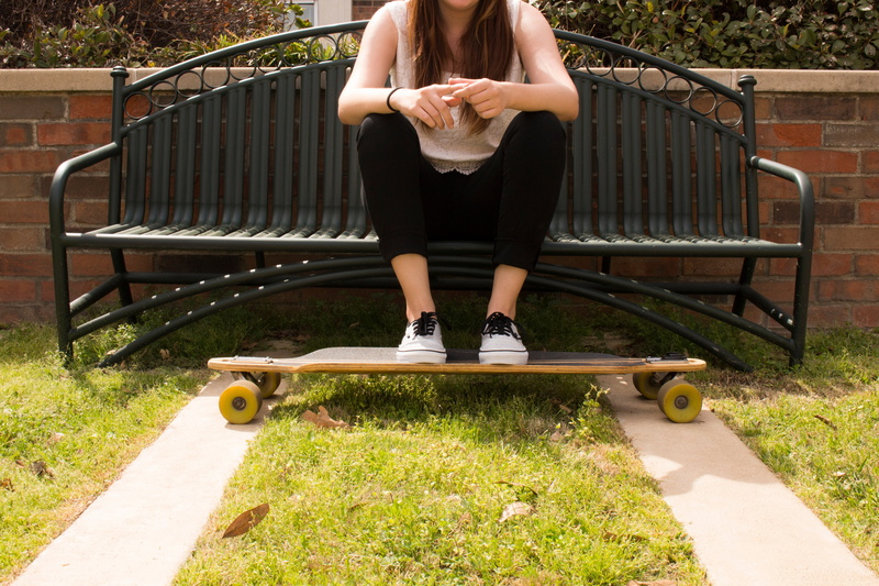 real people, people, outdoors, metal, feet, sitting, woman, day, alone, hairstyle, park, young adult, park bench, adult, steel, game, resting, one person