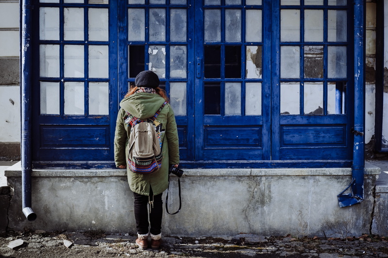 real people, shoe, clothing, women, rear view, woman, building exterior, bag, doors, facade, entrance, built structure, one person, cobalt, architecture