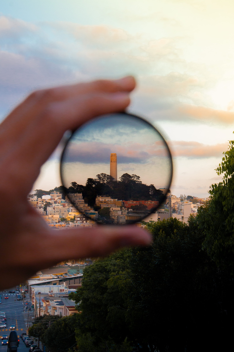 sky, one person, urban, outdoors, sunset, reflection, 5K, built structure, day, circle, cloud - sky, building, plant, city, holding, moody, looking through an object