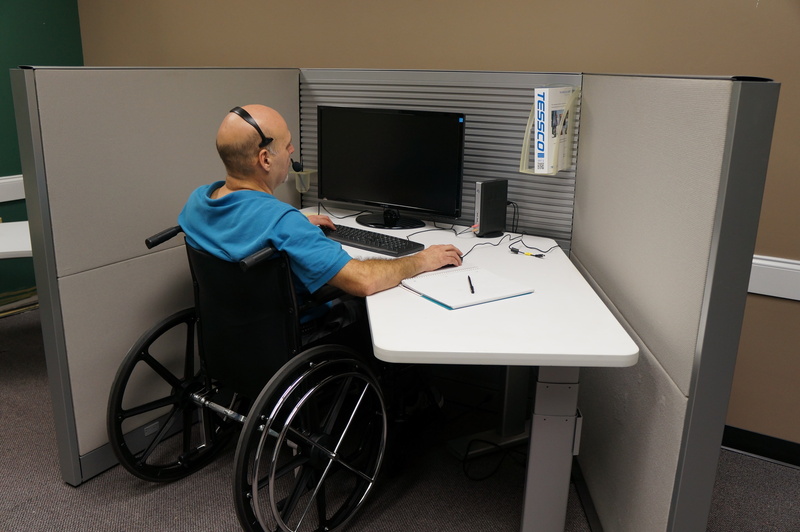 computer, occupation, man, center, sitting, one person, real people, working, adults only, medical equipment, wheelchair, physical impairment, side view