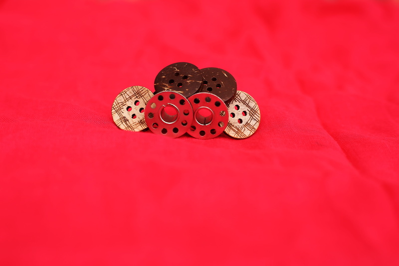 red, group of objects, machine, fabric, reel, embroidery, colorful, emotion, fashion, studio shot, sewing, colored background, spotted, table, bobbin, macro