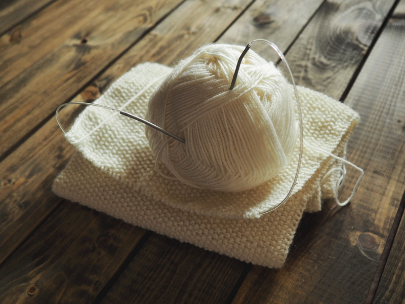 a loop, pastime, ball of wool, knitting, knitting needle, indoors, no people, creativity, selective focus, pattern, high angle view, material, life style
