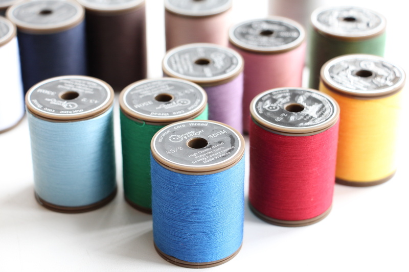 in a row, art and craft, sewing item, still life, variation, group, multi colored, creativity, hobby, indoors, textile industry, studio shot, spool, thread