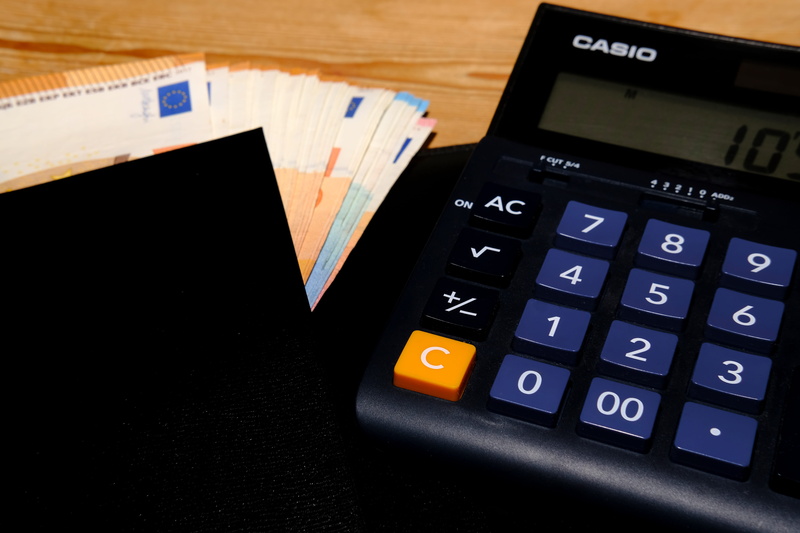 indoors, cash and cash equivalents, euro notes, 5K, number, mathematics, communication, bank note, still life, finance, calculator, text, table, high angle view