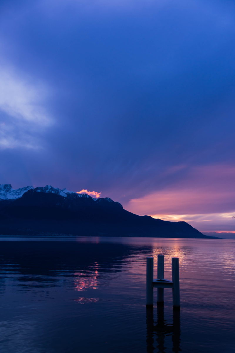 dusk, mountain, moody, pink, clouds, waterfront, idyllic, nature, fire, mountain range, sky, background, water, reflection, blue, winter, no people, wooden post