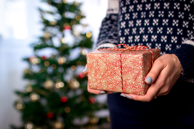 christmas ornament, woman, holding, wrapping paper, gift box, outdoors, gift, box, hands, holiday, tree, christmas, celebration, s, human body part, christmas tree