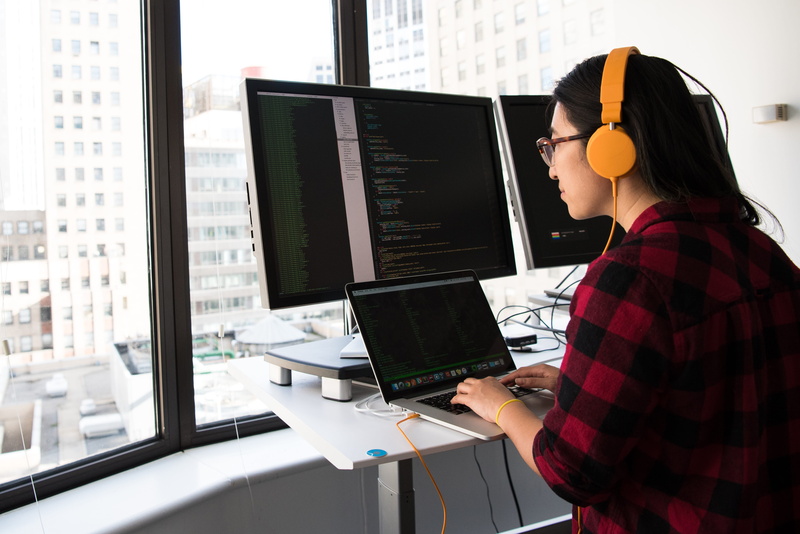 women, working, using laptop, adult, hairstyle, programmer, window, connection, indoors, modern, dual-screen, one person, wireless technology, technology