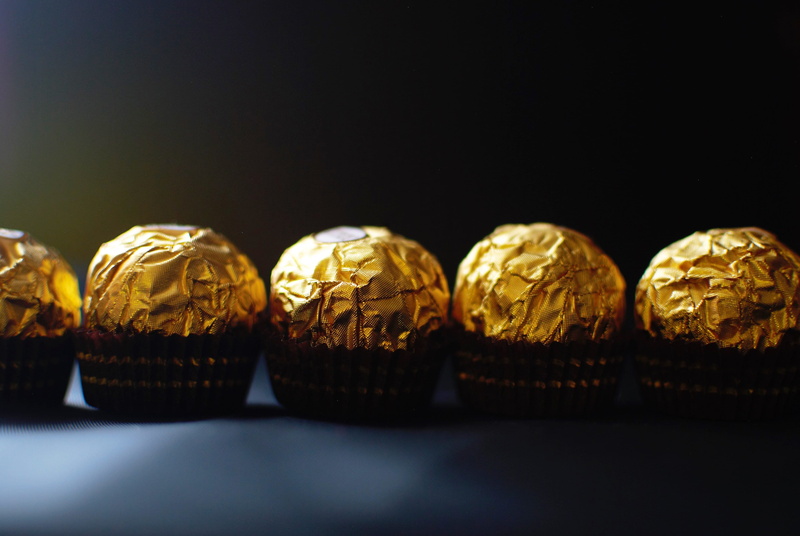 in a row, selective focus, food and drink, foil, no people, sweet food, group of objects, temptation, ferrero rocher, indulgence, luxury, still life, five