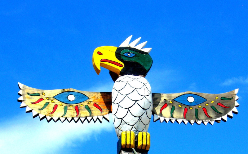 culture, beak, northeast, carved, craftsmanship, totem, sculpture, top, wooden, no people, representation, pole, park, colorful, blue background, day, nature
