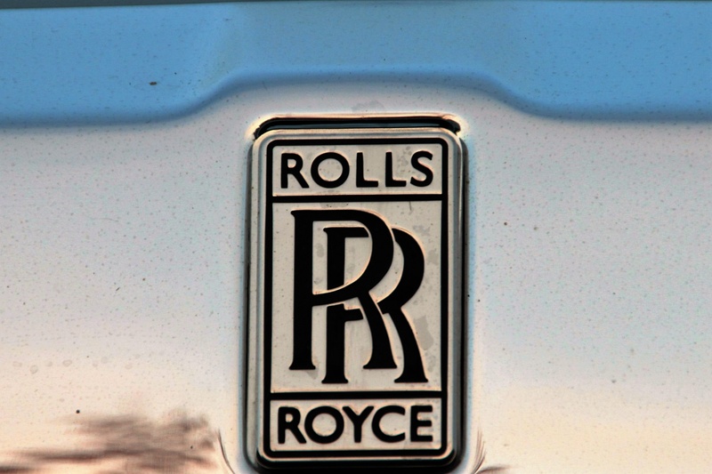 close-up, no people, metal, text, vehicle, capital letter, logo, 2K, number, information sign, white color, brand, rolls royce, nobel, information, communication