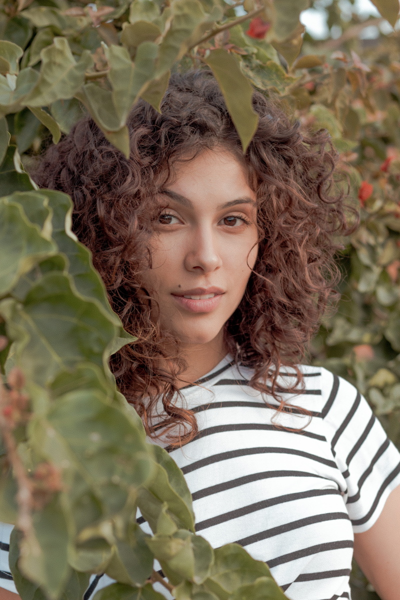 beside, woman, smiling, looking at camera, head, people, growth, stripe, nature, hairstyle, leisure activity, casual clothing, portrait, green, curly hair