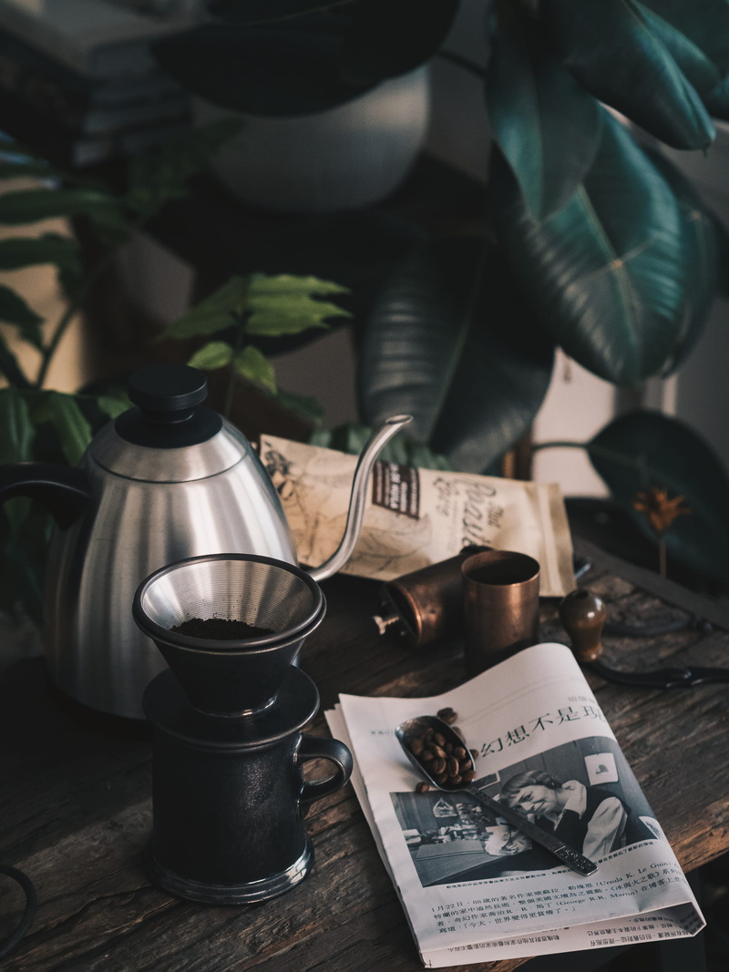 morning light, table, filter coffee, currency, newspaper, steel, beside, 2K, spoon, paper, bokeh, rubber, plant, near, teapot, still life, green, blur