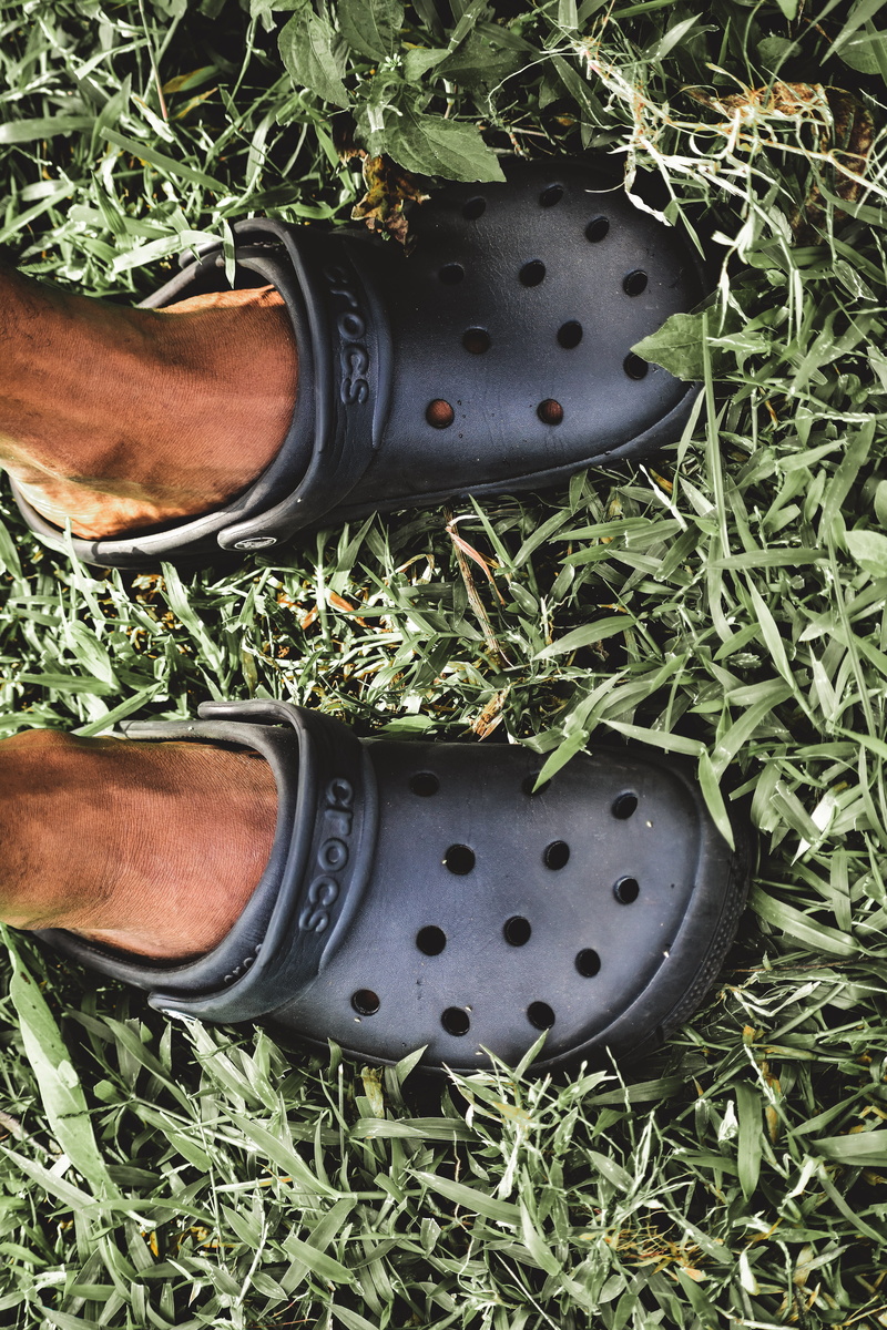 body part, green color, directly above, grass, person, one person, leaf, real people, human body part, human limb, growth, crocs, footwear, feet, ground