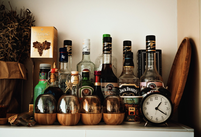 bottle, indoors, 5K, watch, drink, wristwatch, building, tower, table, vodka, clock tower, large group of objects, metropolis, home interior, wall - building feature