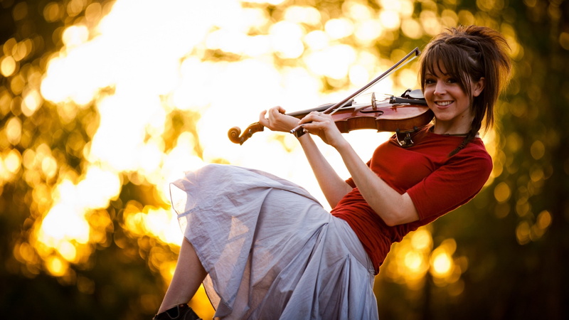 music, beautiful woman, outdoors, adult, young adult, holding, skill, smiling, focus on foreground, 2K, playing, lindsey stirling violin, one person, happiness
