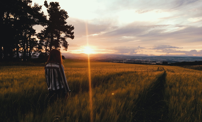 flare, real people, tranquil scene, beauty in nature, cloud - sky, land, united kingdom, environment, girl in field, one person, golden hour, life, tranquility