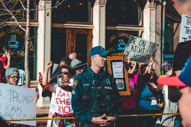 city, leisure activity, women, signs, built structure, action, rally, outdoors, outside, democracy, street, men, crowd, western script, police, adult, text