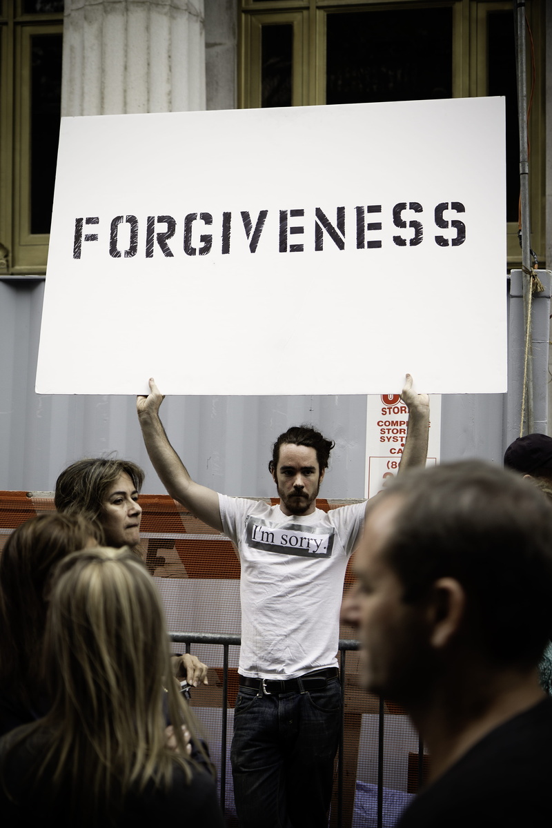 white, occupy, poster, human arm, man, standing, near, group of people, forgiveness, protestor, women, young adult, message, determination, casual clothing