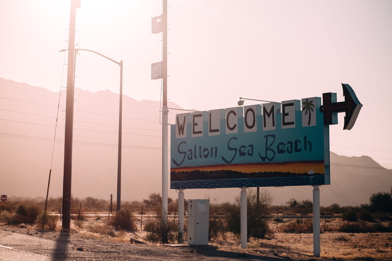 guidance, capital letter, information sign, placard, clear sky, text, road, communication, advertisement, welcome, day, sky, no people, beach, direction