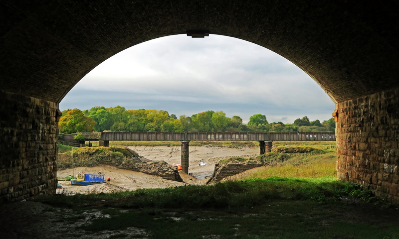 cloud - sky, architecture, bridge, grass, arch bridge, plant, tree, built structure, dry river bed, travel, bridge - man made structure, water, sky, nature