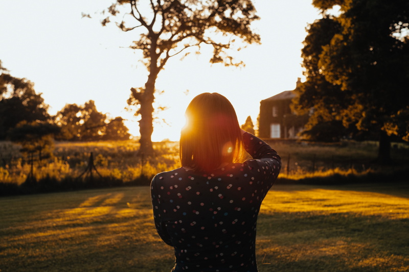 sleeved, sunset, contemplation, rear view, black, beautiful, lens flare, lawn, top, one Woman Only, tree, real people, leisure activity, adults only, women