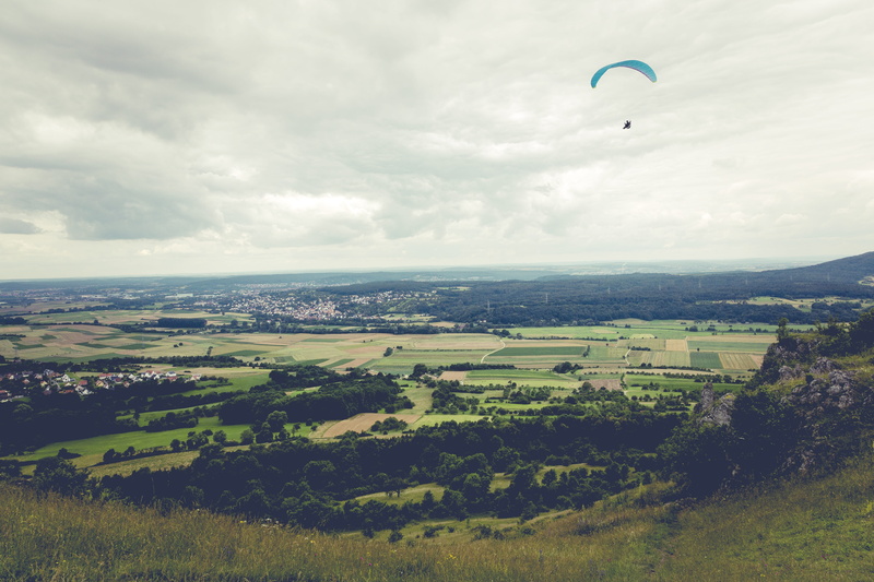 adventure, flight, plant, kite, summer, sky, franconian switzerland, dom, beauty in nature, land, cloud - sky, field, rural scene, freedom, person, extreme sports