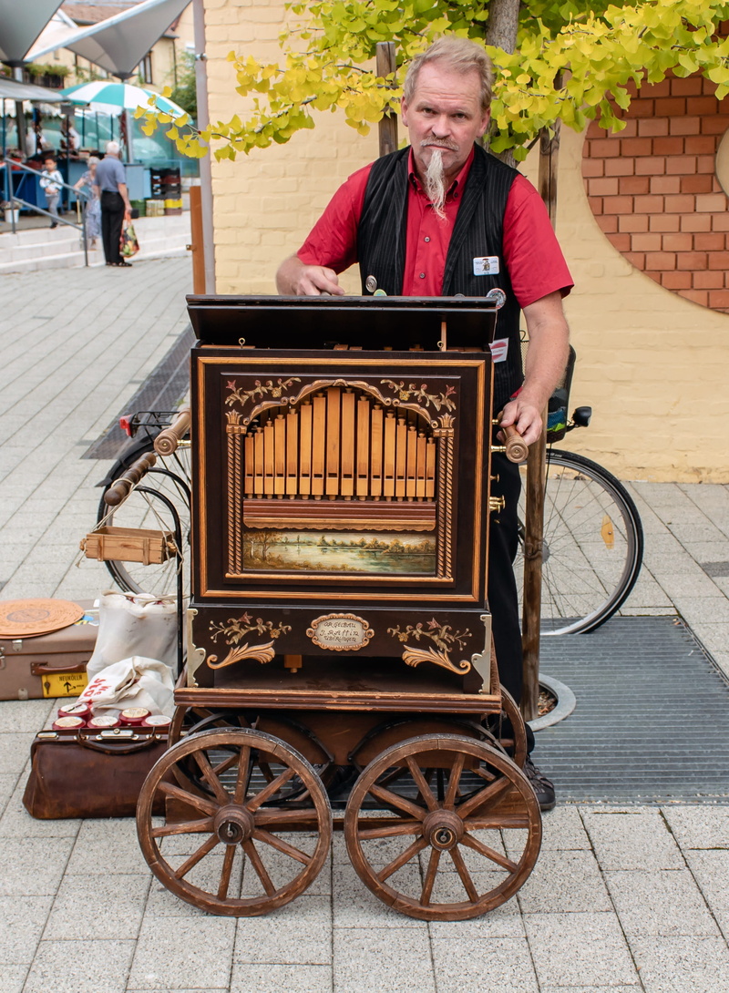 one person, sitting, celebration, front view, looking at camera, music, real people, color, street, 2K, mode of transportation, senior men, men, cultural