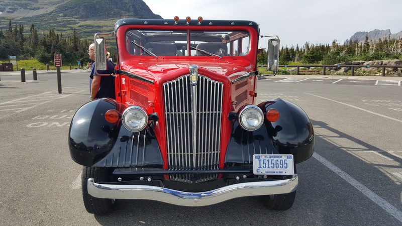 tourists, mountain, front view, sunlight, focus on foreground, stationary, travel, scenic, motor vehicle, old-fashioned, close-up, nature, mode of transportation
