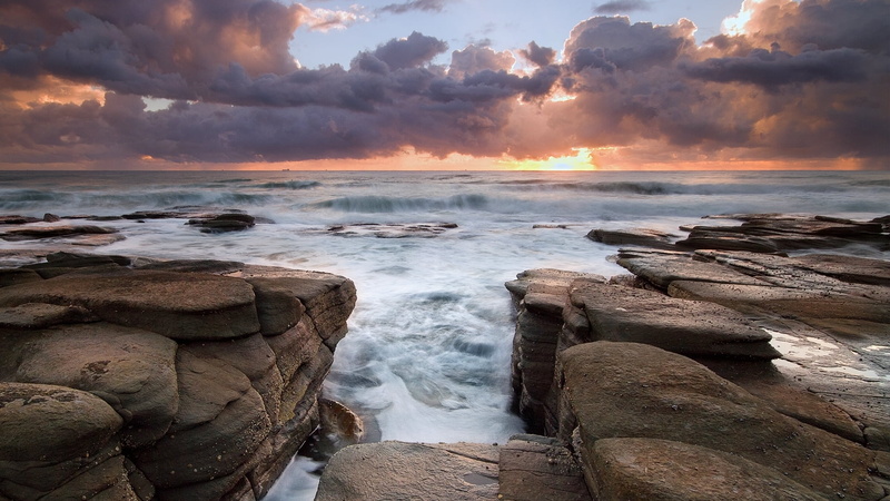 barrier, stone, island, no people, coastline, sea, beauty in nature, sand, horizon, tourism, outdoors, surf, orange color, sun, sunset, land, clouds, summer