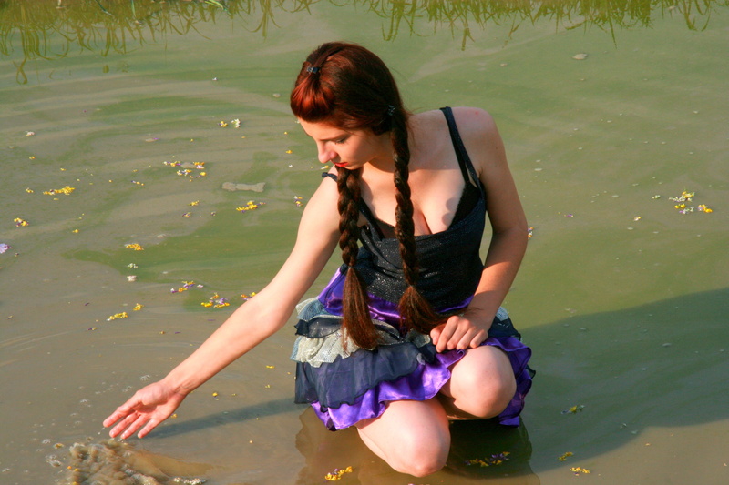 body of water, 4K, black, beauty, sleeveless, leisure activity, sitting, full length, nature, hair, story, water, real people, dress, woman in black, flowers