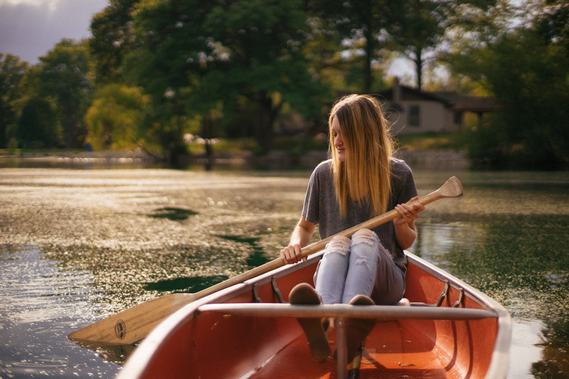 plant, leisure activity, nature, trees, adult, sitting, hairstyle, riding, canoe, tall, lifestyles, lazy, tree, blonde, near, female, sunlight, water, daytime