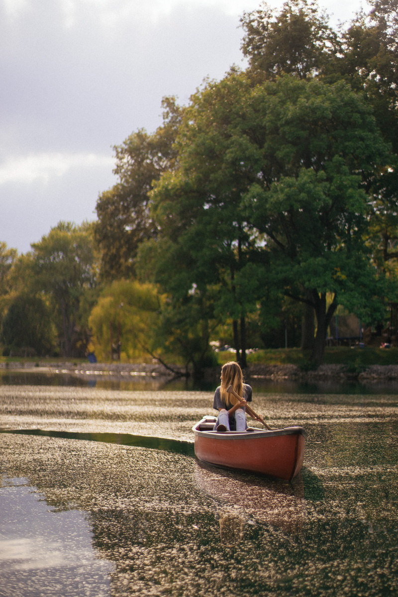 nautical vessel, real people, oar, rowing, women, girl, reflection, tree, daytime, one person, green color, canoe, paddle, female, plant, transportation