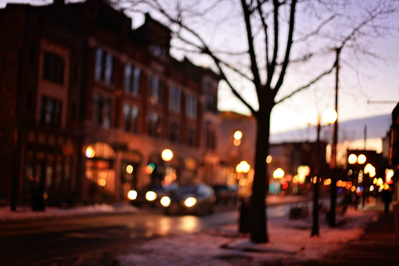 road, evening, town, outdoors, lights, nature, vehicles, building exterior, cars, trees, street light, mode of transportation, dusk, building, bare tree