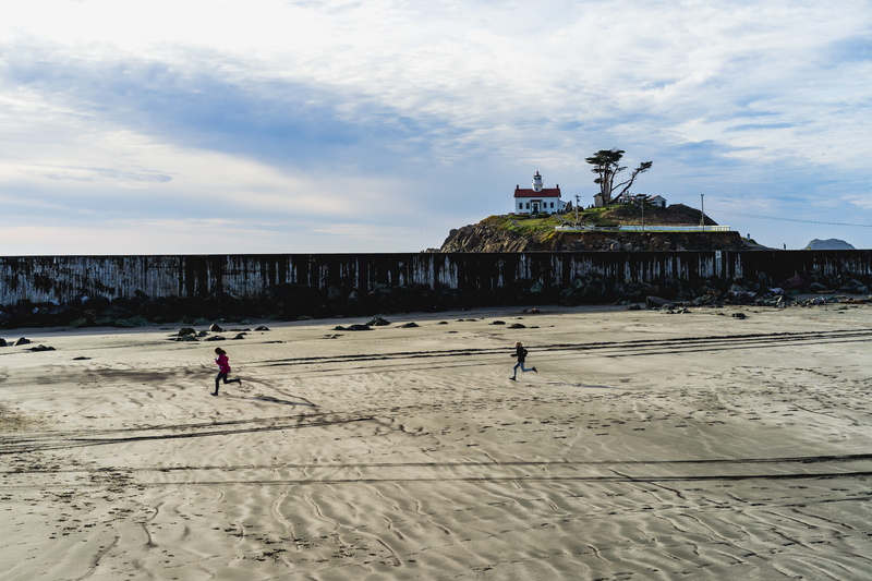 day, sand, crescent city, sky, land, nature, building exterior, sea, lifestyles, incidental people, playing, lighthouse, water, people, kids, united states