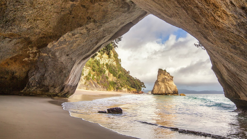 cliff, rock - object, beach, no people, new zealand cathedral cove beach, tranquil scene, land, natural arch, scenics - nature, cloud - sky, tranquility