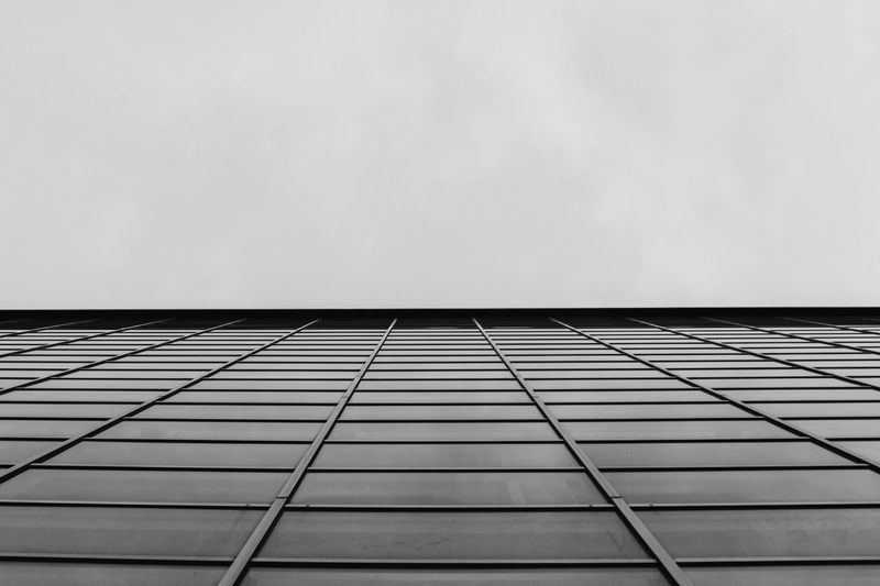 skyscraper, mall, apartment building, building exterior, architecture, directly below, black and white, glass - material, azure sky, office building, urban