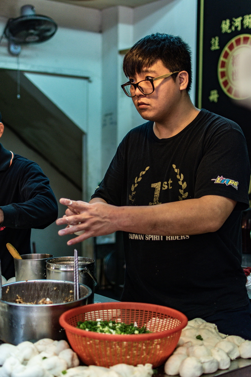 bowl, food court, indoors, people, adult, table, food and drink, human, freshness, shirt, accessories, preparing food, meal, eyeglasses, lifestyles, bartender