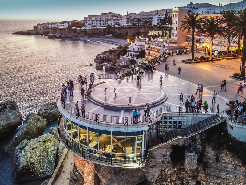 travel destinations, high angle view, sunset, travel, real people, lifestyles, adult, lights, nerja, built structure, architecture, walk, nature, transportation