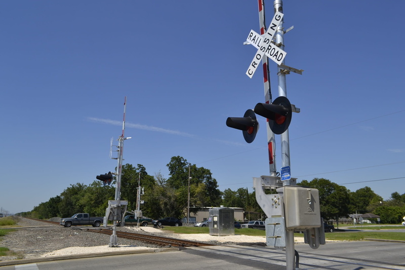 sunlight, track, crossing sign, no people, transport, sign, rail transportation, strange cloud, street, railroad crossing, road, outdoor, light, road sign
