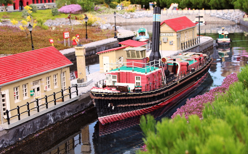 boat, city, legoland, nature, theme park, mode of transportation, day, building, water, flower, building blocks, nautical vessel, canal, close up, build