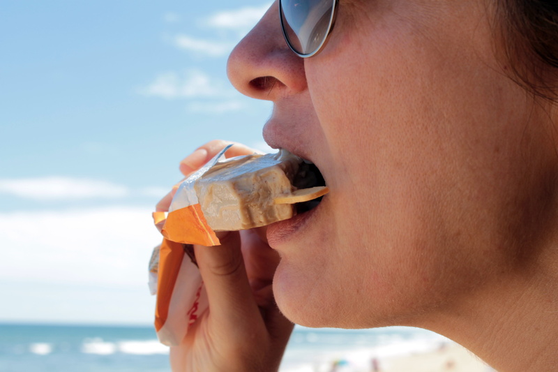 one person, fruit flavor, side view, drinking, food and drink, sea, refreshment, close, portrait, ice cream, adult, young adult, person, day, leisure activity