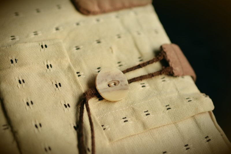 yellow, art and craft, sewing, textile industry, natural material, brown, no people, thread, bag, hand labor, indoors, book, textile, pattern, button, material