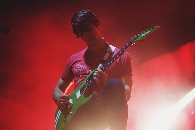 performing Arts Event, musician, guitar, musical Band, one person, playing, music, plucking An Instrument, stage - Performance Space, on-stage, light, party