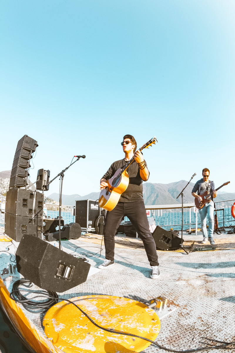 instruments, band, guitar, day, clear sky, happiness, sky, enjoyment, real people, art, performers, looking at camera, front view, casual clothing, song