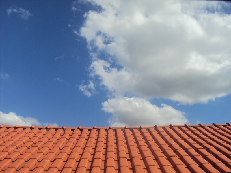 high section, terracotta, red, city, cloud - sky, roof, residential district, no people, blue, sky, pattern, outdoors, horizon, sunlight, immensity, building exterior