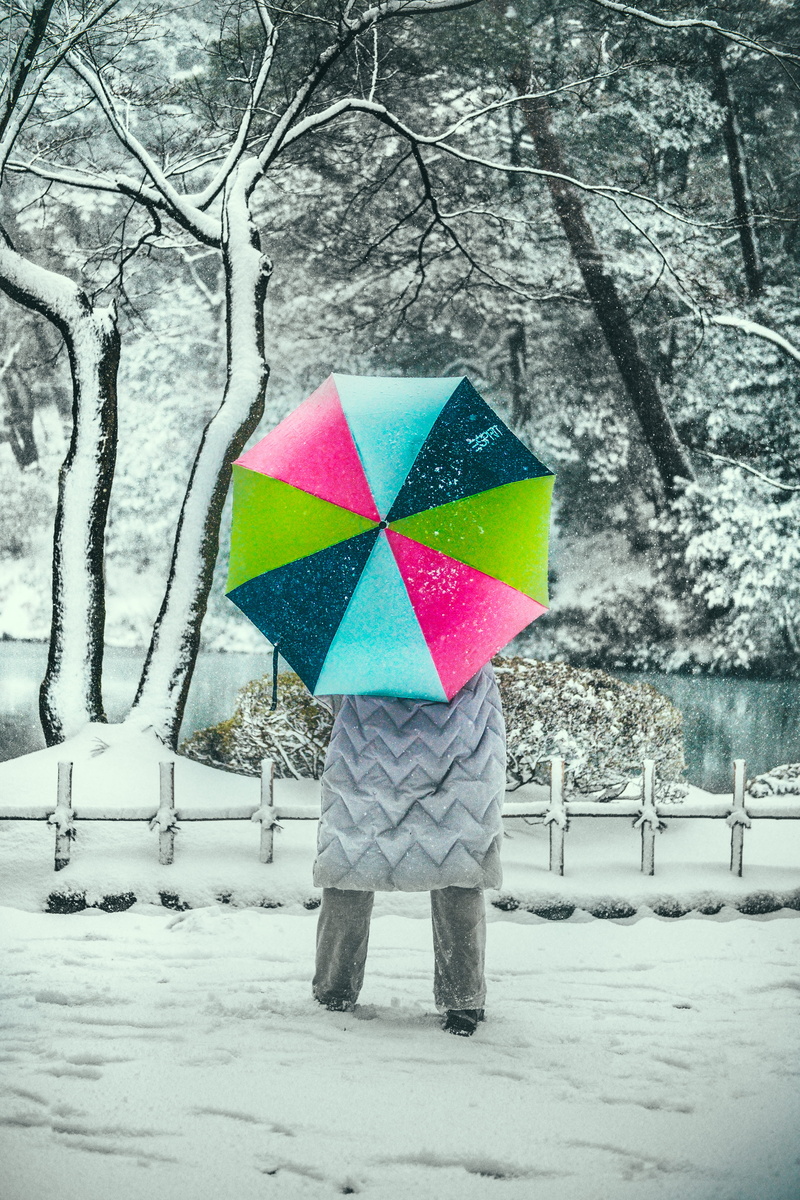person, storm, leisure activity, warm clothing, outdoors, childhood, rain, one person, umbrella, cold temperature, standing, winter, covering, snow, building