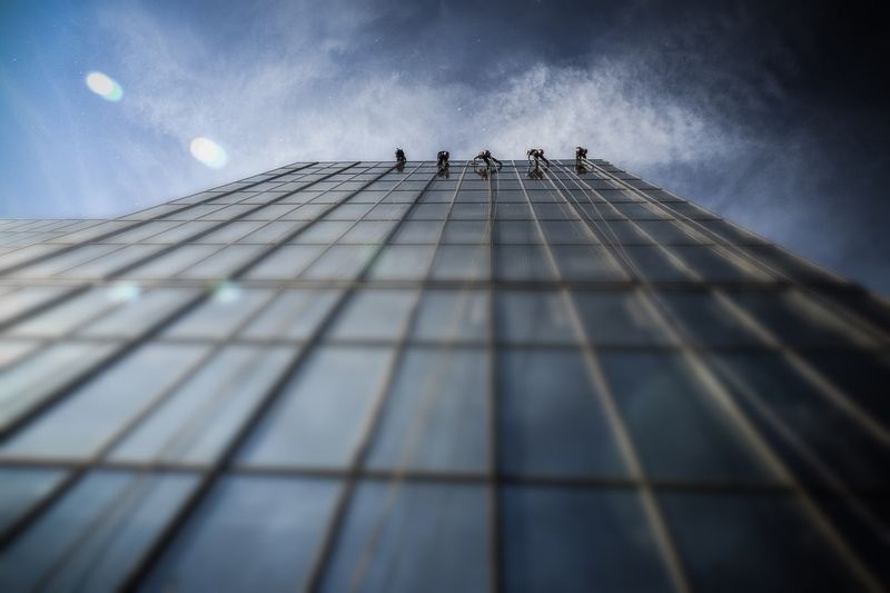 glass - material, window cleaner, architecture, office building exterior, modern, directly below, cloud - sky, day, tall - high, group of people, sunlight